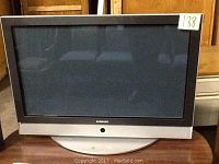 Samsung SP-R4212 Plasma TV with silver bezel and base stand, model visible on bezel, screen off.