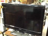 Photo of the Philips 32-inch flatscreen television with black bezel and stand, model visible on the unit.