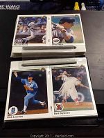Four baseball cards laid out on a dark surface showing players Marvell Wynne, Greg Gagne, Rick Luecken, and Bert Blyleven.