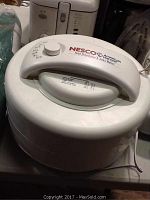 Photo showing the top view of the white Nesco American Harvest food dehydrator with visible control dial and handle.