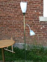 Front view of the floor lamp showing the 71-inch height, white torchiere top shade, green pole, and small metallic adjustable arm shade.