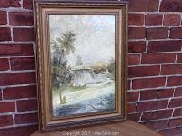 Framed watercolour painting showing full view of the river falls artwork in an antique wooden frame.