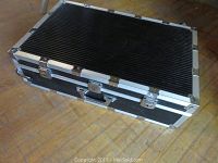 Closed black Le Roncato Clak carrying case with aluminum trim and locks on wood floor.
