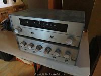 Photo showing two stacked Olson electronics units on a table, the top unit is RA-628 tuner and the bottom unit is AM-253 amplifier.