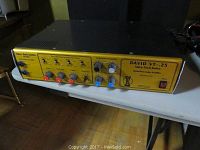 Angled front view of amplifier on table showing overall unit and control panel layout with visible wear
