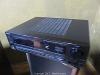Front and side view of the Sony STR-AV770 FM Stereo FM-AM receiver showing display, control buttons, volume knob, and speaker selector.