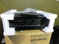 Kenwood KR-V8020 receiver in foam packaging on original box, front view.
