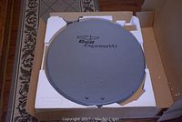 Bell ExpressVu branded 60 cm satellite dish in original Styrofoam packaging, showing overall condition and branding.