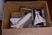 Top view of the box containing models including space shuttle, CF-105 and CF-100 boxed models with parts showing wear and missing pieces