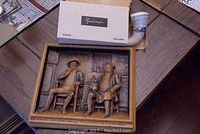 Ceramic plaque and porcelain pipe on table with original box