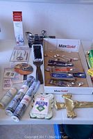 Photo of table showing collector spoons, grooming brush, water filter box, and other items spread out.