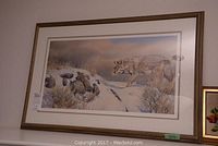 Front view of gallery framed print of a coyote in snow in gold-tone wood frame