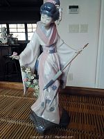 Full front view of the Lladro geisha figurine showing kimono, parasol, and base