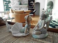 Overall view showing both porcelain figurines on wooden surface
