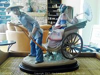 Front-side view of porcelain figurine showing both rickshaw puller and seated woman.