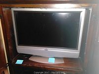 Front view of the Westinghouse 32-inch LED TV showing the screen and curved silver base stand.