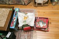 Overhead photo showing assorted boxes and wrapped items including train set box and holiday plates