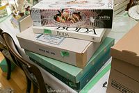 Boxes stacked including Trellis Circleware 5-piece divided dish, Kosta Boda serving tray, Hellerware lazy Susan, Dominion Glass server.