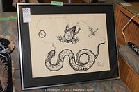Full front view of framed artwork showing black ink drawing of snake, frog, and abstract shapes