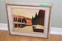 Frontal view of the framed oil painting by D E Boocock, showing the landscape with trees and river, size sticker visible.