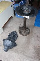 Two fountain pieces shown together with one standing and one lying down