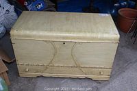 Front view of painted cedar lined wooden chest noted to have marks and wear.