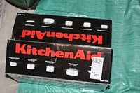 Box showing KitchenAid brand and illustration of the cookware set.