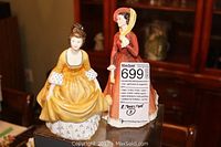 Both Royal Doulton figurines together: Coralie in yellow dress and Julia in red dress holding parasol