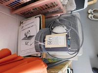 Cardboard box with second printed manual and clear bag of assorted small rubber rings