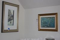 Two framed prints on a wall: one vertical with the Venetian canal and gondolier, the other a horizontal Almond Blossom print in gold frame.