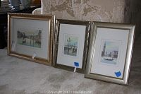 Three framed hand-tinted Venetian prints displayed leaning against a wall on floor.