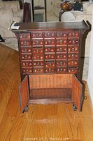 Front view of apothecary cabinet showing 30 small drawers and lower cabinet