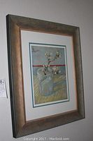 Framed print hanging on wall showing entire artwork and frame