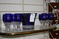 Overview of ice bucket and eight goblets on shelf