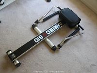 Rowing machine showing side view with seat, frame, and roller wheels.
