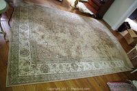 Full view of the rug on hardwood floor showing overall pattern and size.