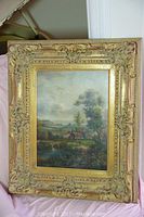 Full front view of framed painting showing entire ornate gilt frame and landscape scene