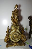 Overall front view showing entire clock and seated female figure on top