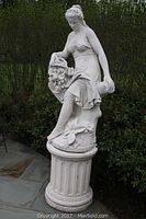 Full view of statue mounted on fluted column pedestal