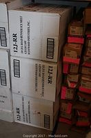 Stack of sealed Road Runner ice melt boxes showing printed product code and brand