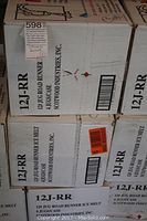 Stack of sealed cardboard cases labeled 12J-RR Jug Road Runner Ice Melt