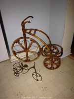 Large bamboo tricycle-shaped plant holder showing the frame, wheels and two holders for pots.