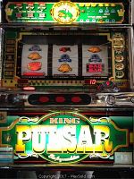 Front view showing illuminated signage, reels and control panel