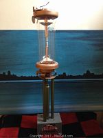 Full view of the Jennings vacuum relay showing glass tube, copper components, metal base, and wiring connections