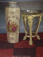 Front view of ceramic vase with painted scene and glass holder with gold-colored ornate stand