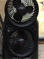 Close-up of the upper and lower fan heads with Honeywell logos and control knobs