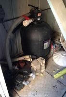 Overall view of assembled sand filter and pump with PVC plumbing fittings