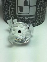 Front view of Swarovski Silver Crystal Blowfish in front of original box showing faceted clear crystal body with frosted fins and black eyes.