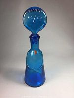 Full view of the cobalt blue figural decanter showing the body and stopper with a face design.