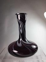 Front view of amethyst blown glass bottle vase showing bottle shape, white swirl pattern, and flattened neck